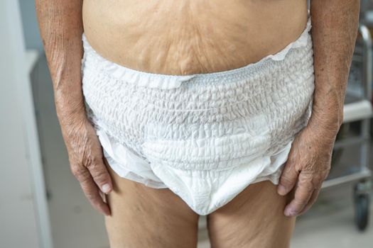 Asian senior or elderly old lady woman patient wearing incontinence diaper in nursing hospital ward, healthy strong medical concept.