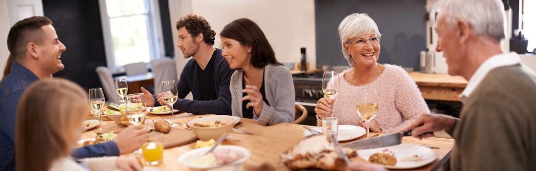 Shot of a family sitting down to dinner.