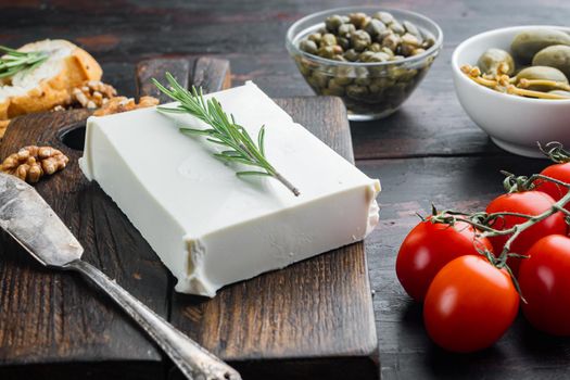 Raw organic white feta cheese set, on dark wooden background