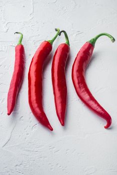 Whole red chili peppers set, on white background, top view or flat lay