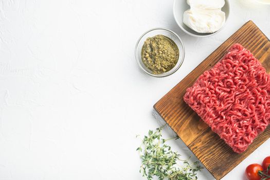 Raw meatballs made from ground beef ingredients set, on white stone background, top view flat lay, with copy space for text