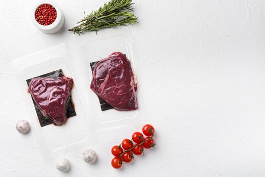 Pack with fresh rump beef steak set, on white stone table background, top view flat lay, with copy space for text