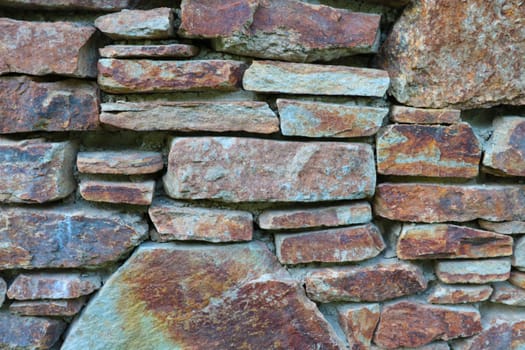 The texture of the stone wall of the building or structure, the background of the stone