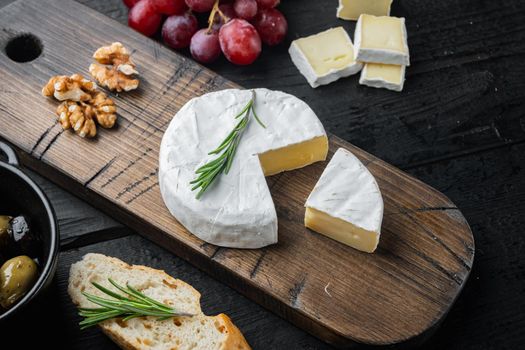 French camembert cheese set, on black wooden table