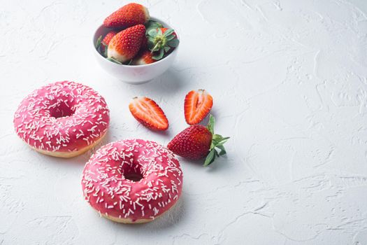 Pink strawberry flavor donuts, on white background with copy space for text