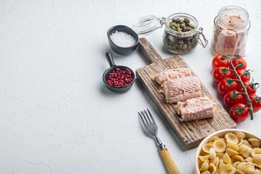 Delicious lumaconi pasta meal with tuna and baby capers, on white background with copy space for text