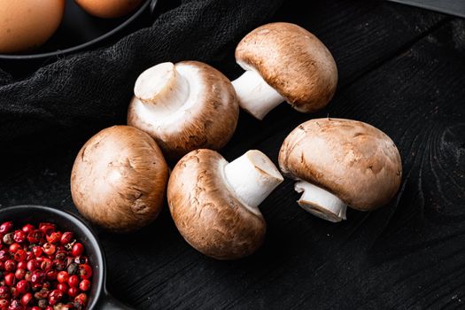 Royal mushrooms champignon whole set, on black wooden table background