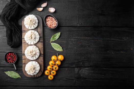 Homemade, traditional chinese pan fried dumplings set, on black wooden table background, top view flat lay, with copy space for text