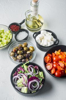 Ingredients for traditional greek salad, Tomatoes, onion, olives, feta cheese, on white background