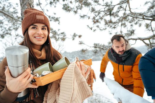 Young woman taking luggage out of car on winter trip, close up