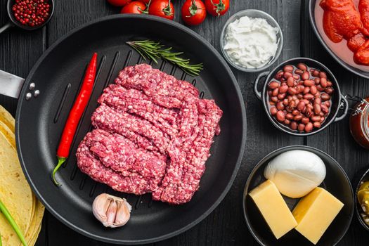 Ingredients for mexican quesadilla with salsa sauce, on black wooden table background, top view flat lay