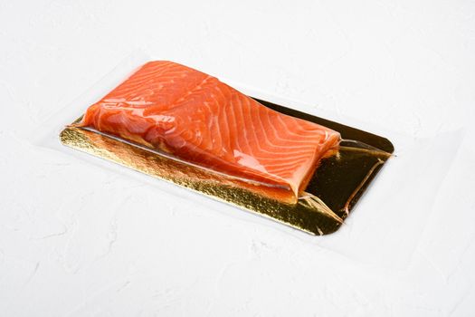 Salmon fillet vacuum pack fish meat set, on white stone table background, with copy space for text