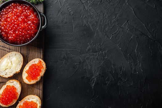 Canape with Red Salmon Caviar, for New Year, on black background, top view flat lay with copy space for text