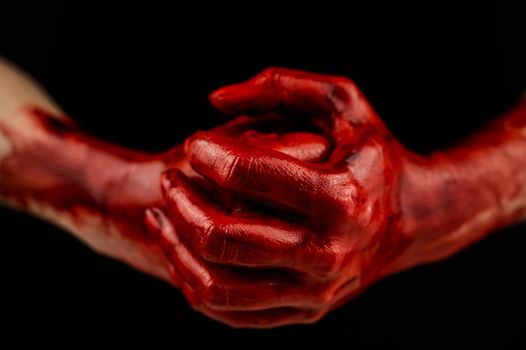 Women's fists in blood on a black background. Fist and palm