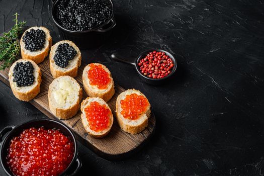 Sandwiches with red and black caviar baguette, on black background with copy space for text