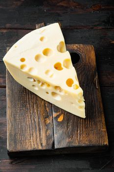 Maasdam cheese set, on old dark wooden table