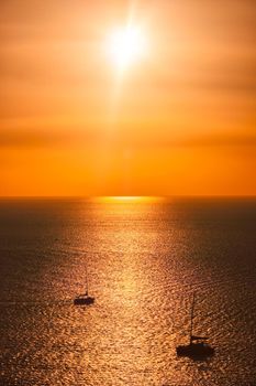 Yacht boats silhouettes in Aegean sea on sunset. Mykonos, Greece