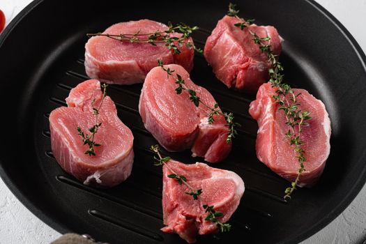 Raw pork fillet, on white stone table background