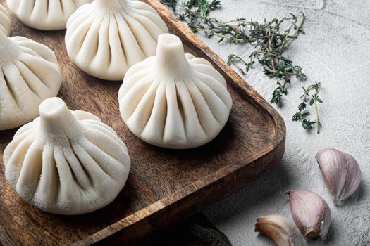 Frozen Raw dumplings Khinkali with beef and lamb meat set, on gray stone background, with copy space for text