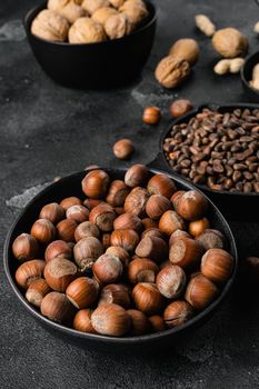 Organic Hazelnut whole nuts set, on black dark stone table background