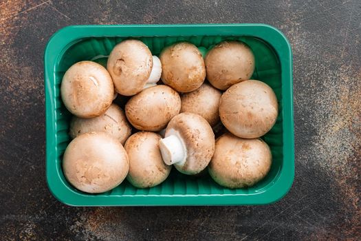 Royal champignons, Parisian champignons set, on old dark rustic background, in plastic pack, top view flat lay