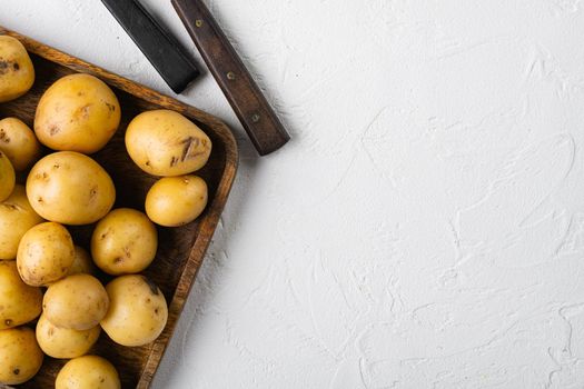 Heap of baby potatoes set, on white stone table background, top view flat lay, with copy space for text