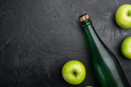 Apple cider vinegar or fermented fruit drink set, on black dark stone table background, top view flat lay, with copy space for text