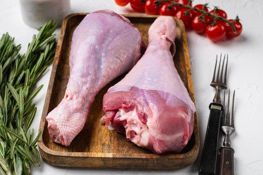 Fresh turkey legs with ingredients for cooking set, on white stone table background