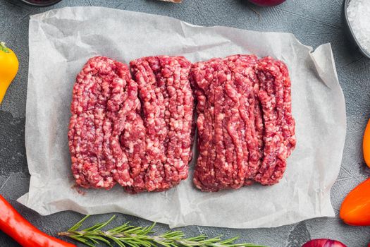 Raw minced fresh meat, on gray background, top view flat lay