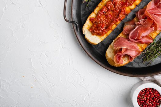 Italian tomato, prosciutto, jamon, ham and cheese bruschetta set, top view flat lay, with copy space for text