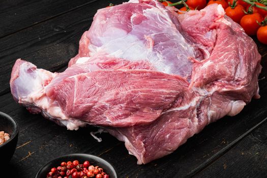 Fresh meat with herbs, oil and spices set, on black wooden table background, top view flat lay