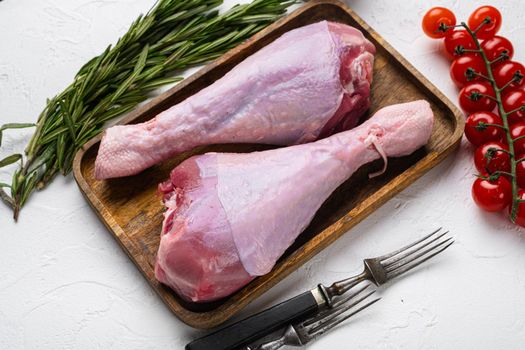 Turkey raw meat leg, on white stone table background