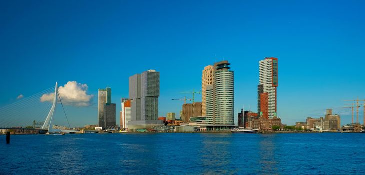 Panorama of Rotterdam skyscrapers skyline and Erasmusbrug bridge view over of Nieuwe Maas river. Rotterdam, the Netherlands