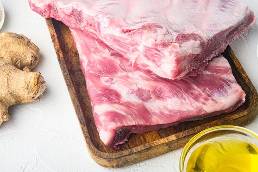 Fresh raw pork meat from organic farm with spices set, with honey, on white background, with copy space for text