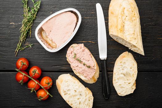 Liver pate on toast set, on black wooden table background, top view flat lay