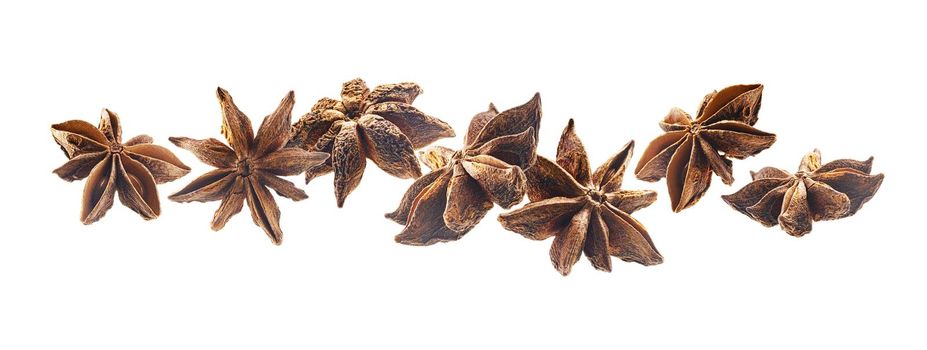 Anise stars levitate on a white background.