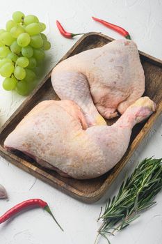 Organic chicken legs with spices and garlic set, on white background