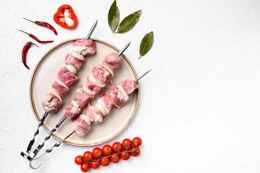 Kebab with spices and herbs, pork meat set, top view flat lay, with copy space for text, on white stone table background