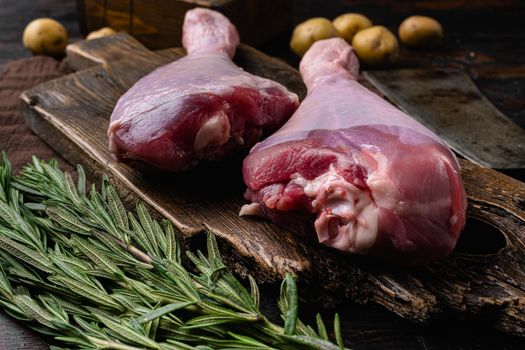 Turkey raw meat leg, on old dark wooden table background