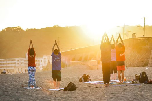 Sunset sandy beach and yoga. Shooting Location: Kamakura City, Kanagawa Prefecture