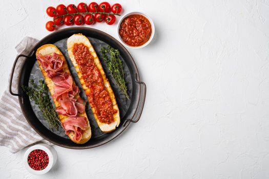 Toasted bread slice with fresh tomatoes and cured ham set, top view flat lay, with copy space for text