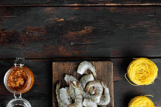 Traditional Italian dish. pasta with pesto ricotta parmesan and grilled seafood ingredients set, on old dark wooden table, top view flat lay, with copy space for text