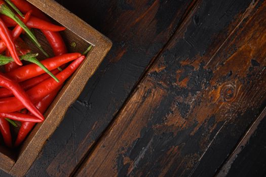 Hot Red thai pepper set, in wooden box, on old dark wooden table, top view flat lay, with copy space for text