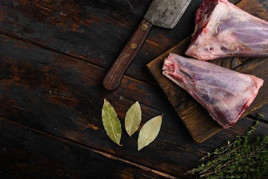 Raw lamb shanks meat set, on old dark wooden table background, top view flat lay, with copy space for text