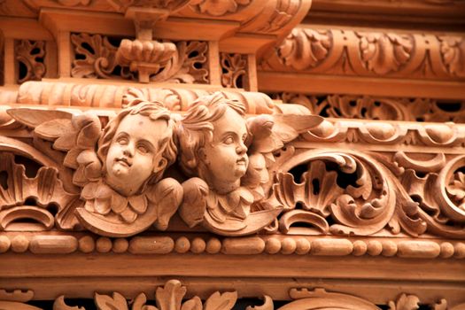 Elche, Spain- April 13, 2022: Beautiful wooden details of Easter Parade with bearers and penitents through the streets of Elche city in the Holy Week