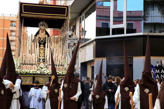 Elche, Spain- April 13, 2022: Virgin Mary on Easter Parade with bearers and penitents through the streets of Elche city in the Holy Week