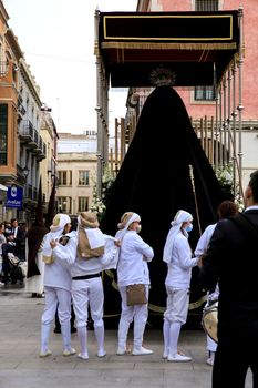 Elche, Spain- April 13, 2022: Virgin Mary on Easter Parade with bearers and penitents through the streets of Elche city in the Holy Week