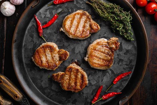 Grilled pork fillet meat, on old dark wooden table background, top view flat lay