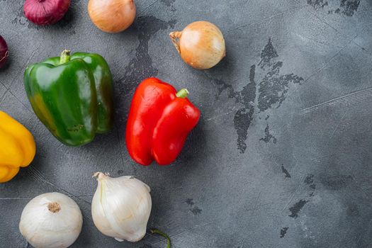 Collection of vegetables Bell pepper and onion, on gray background with copy space for text