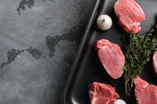 Pork meat fillet, on gray stone table background, top view flat lay, with copy space for text